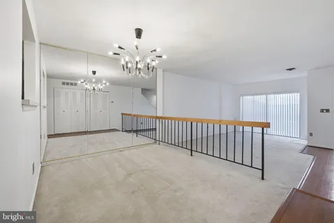 a view of a livingroom with a chandelier fan