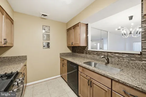a kitchen with stainless steel appliances granite countertop a stove and a microwave