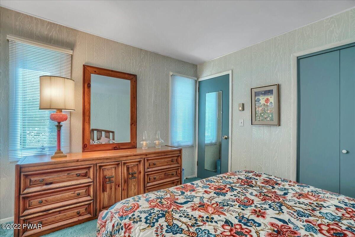 110 Ridge Road Hawley, PA 18428 - Photo 29 of 49 a bedroom with a bed and a dresser in it