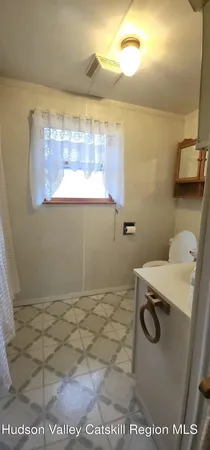 a kitchen with stainless steel appliances granite countertop a refrigerator a stove a sink and chairs