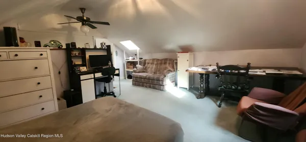 a bedroom with furniture and window