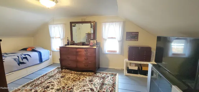 a bed room with a bed mirror and a window