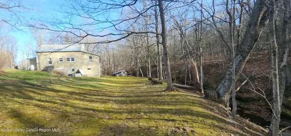 a view of a backyard with large trees