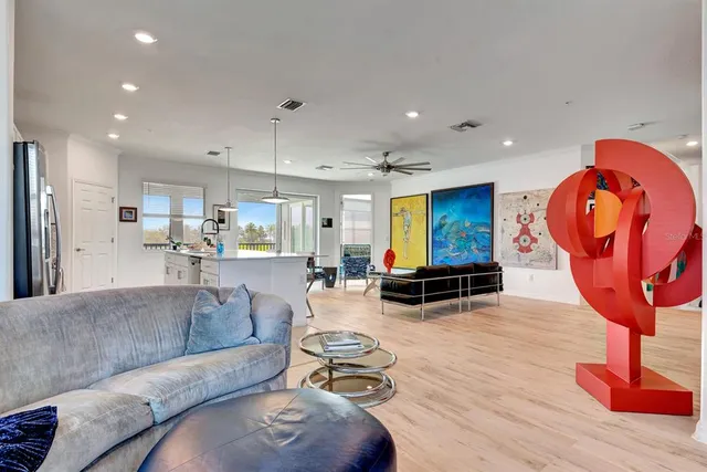 a kitchen with kitchen island a sink and a stove with wooden floor