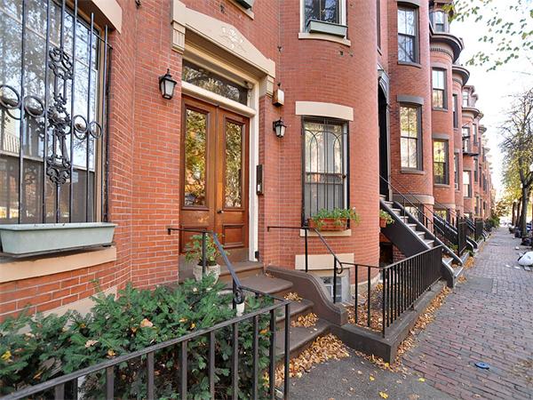 124 Chandler Street, Unit A Boston, MA 02116 - Photo 12 of 14 a view of a brick house with many windows and plants