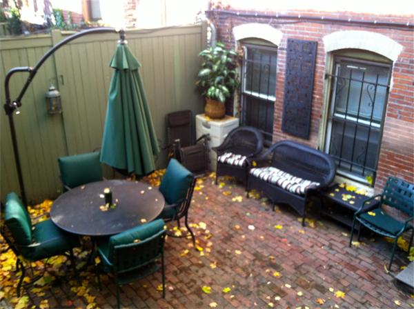 124 Chandler Street, Unit A Boston, MA 02116 - Photo 13 of 14 a backyard of a house with table and chairs