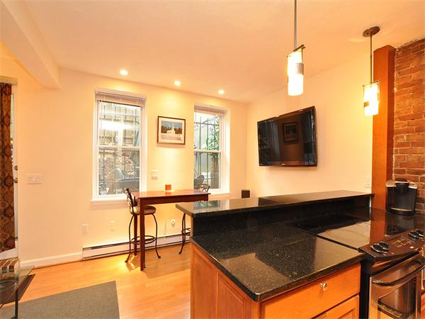124 Chandler Street, Unit A Boston, MA 02116 - Photo 5 of 14 a kitchen with stainless steel appliances granite countertop a sink a stove and a refrigerator