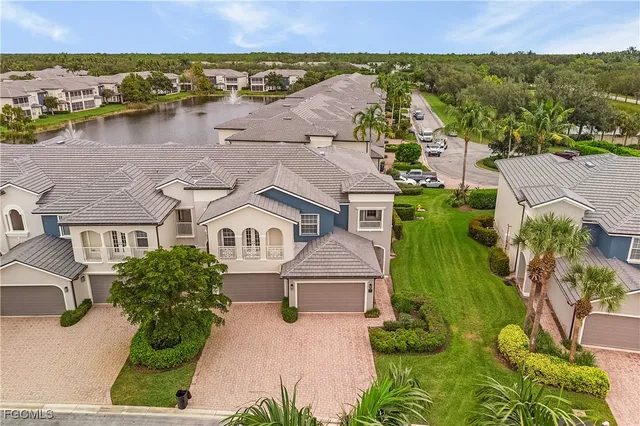 an aerial view of multiple houses with yard