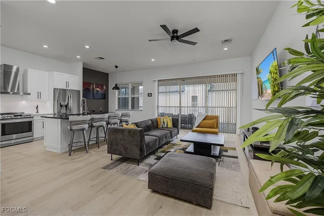 a living room with furniture and kitchen view