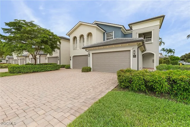 a view of a white house with a big yard and large tree