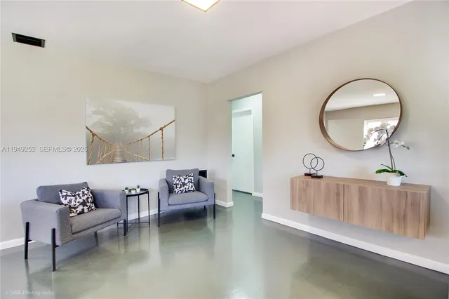 a living room with furniture and a mirror