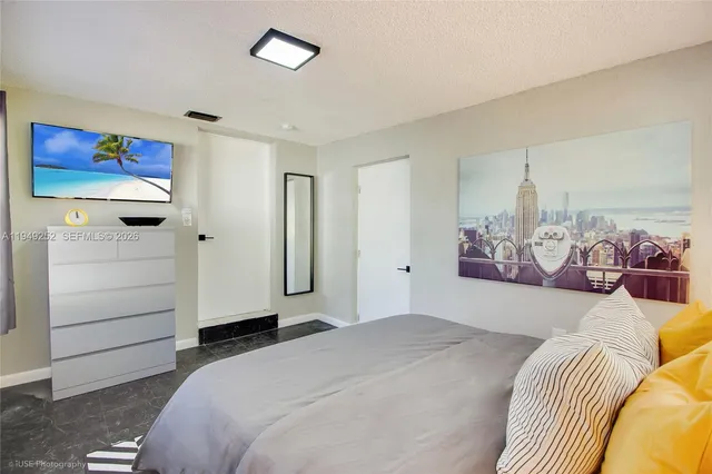 a bedroom with a bed and a view of bedroom