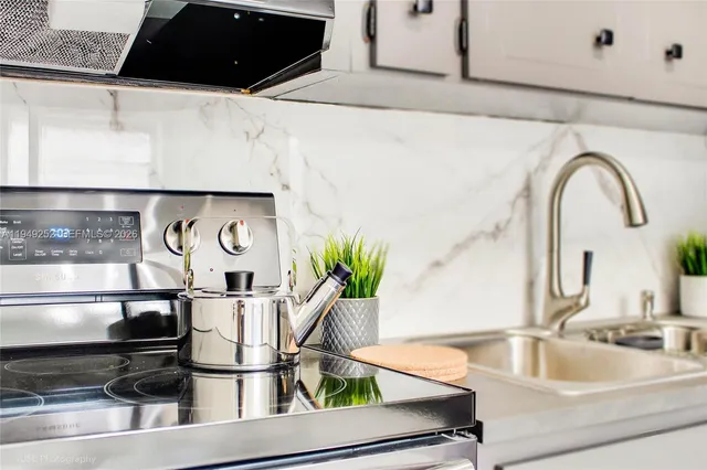 a kitchen with a refrigerator and sink
