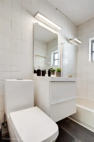 a bathroom with a sink a toilet and bathtub