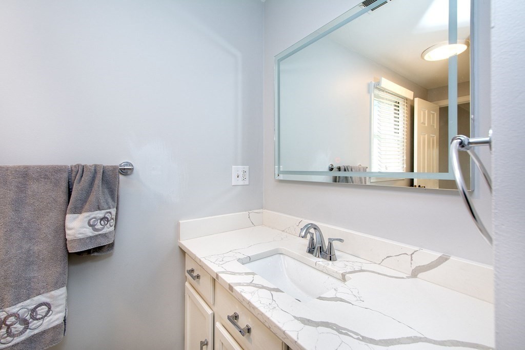 213 Beaver Dam Road Scituate, MA 02066 - Photo 11 of 28 a bathroom with a sink and a mirror
