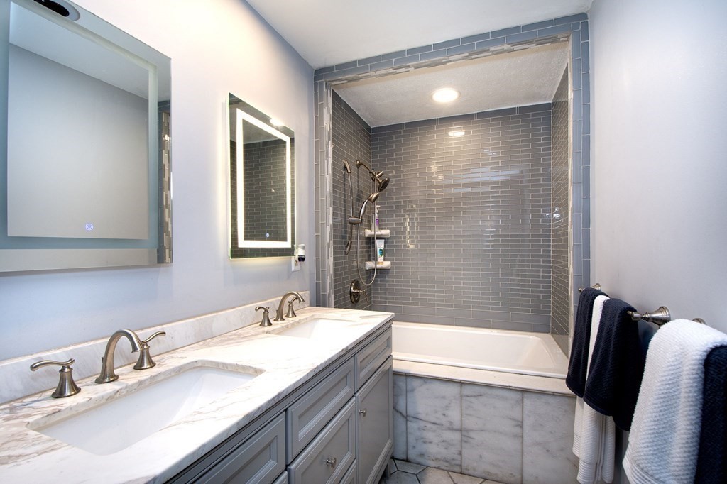 213 Beaver Dam Road Scituate, MA 02066 - Photo 12 of 28 a bathroom with a granite countertop bathtub sink vanity and mirror