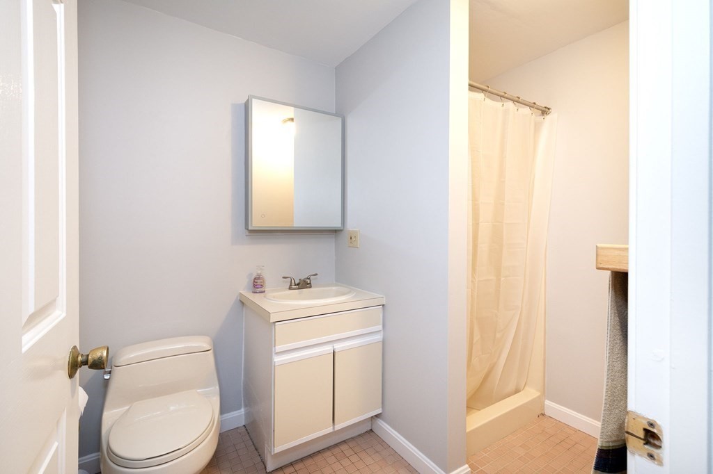 213 Beaver Dam Road Scituate, MA 02066 - Photo 14 of 28 a white toilet sitting next to a bathroom sink