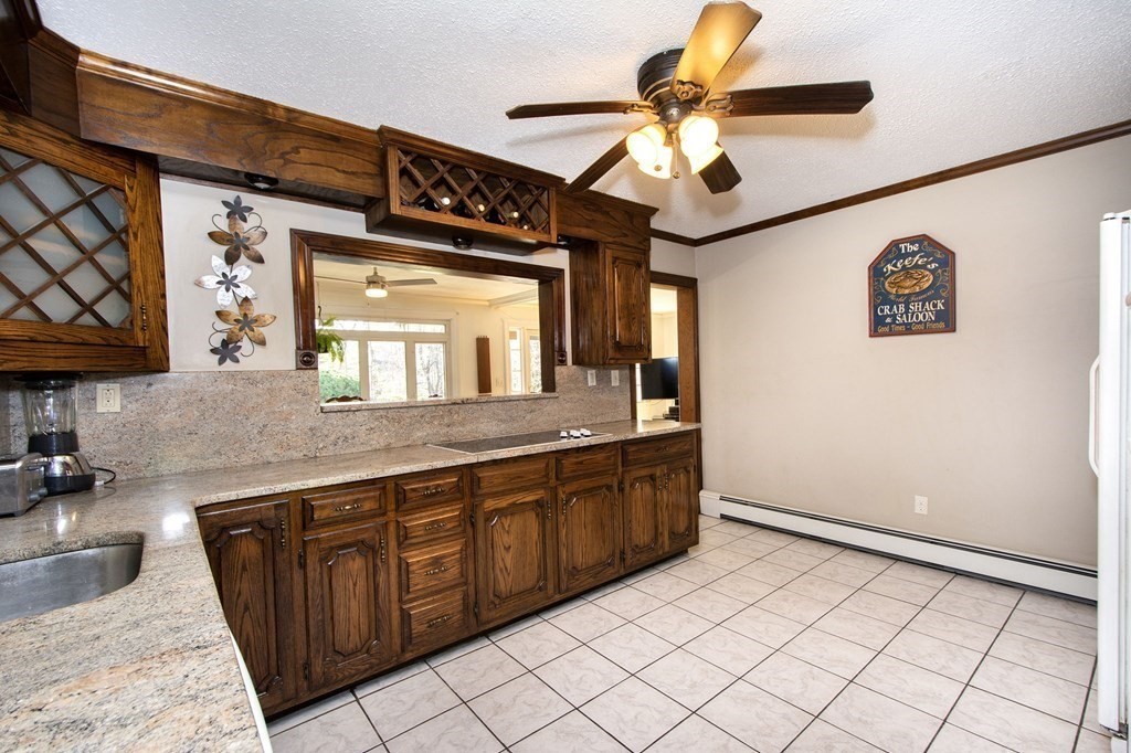 213 Beaver Dam Road Scituate, MA 02066 - Photo 19 of 28 a kitchen with stainless steel appliances granite countertop a sink and a white cabinets