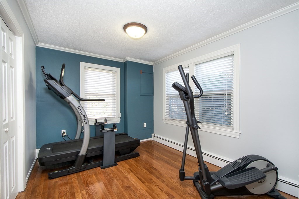213 Beaver Dam Road Scituate, MA 02066 - Photo 22 of 28 a room with gym equipment and wooden floor