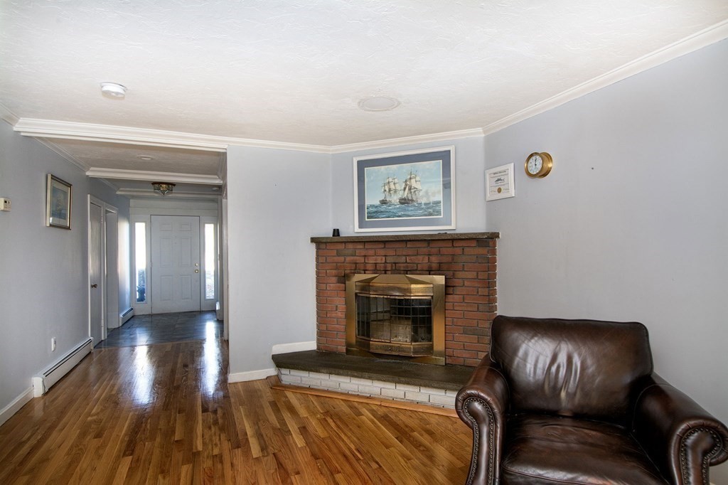 213 Beaver Dam Road Scituate, MA 02066 - Photo 23 of 28 a living room with furniture and a fireplace
