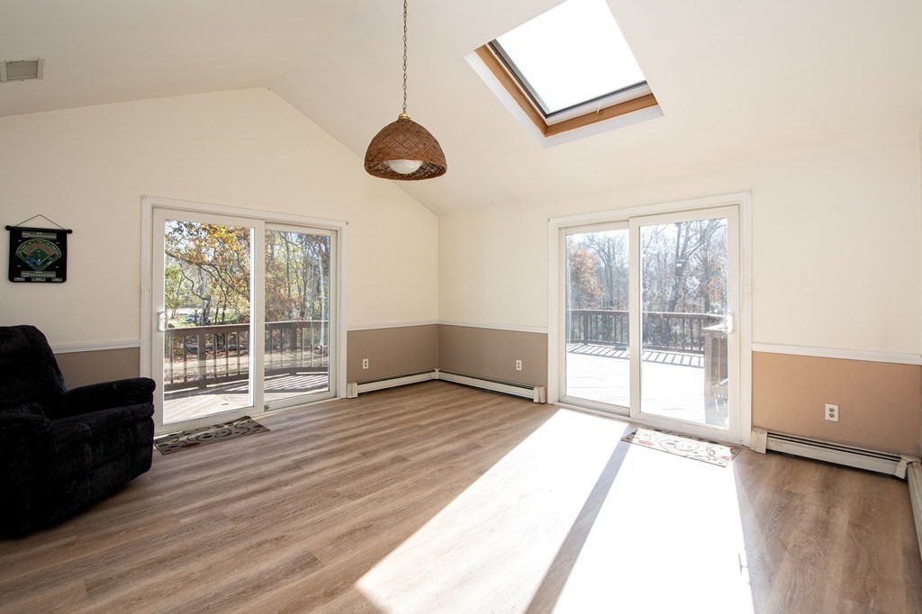 213 Beaver Dam Road Scituate, MA 02066 - Photo 5 of 28 a view of an empty room with wooden floor and a window