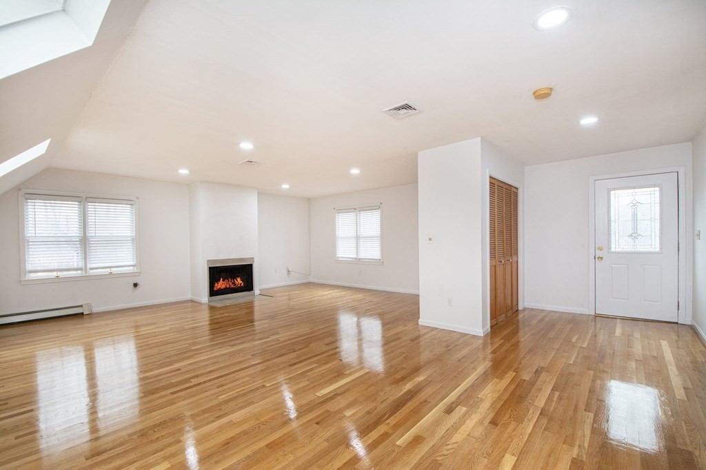 213 Beaver Dam Road Scituate, MA 02066 - Photo 8 of 28 a view of an empty room with wooden floor and a window