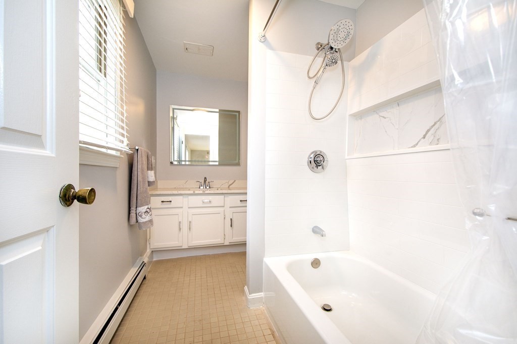 213 Beaver Dam Road Scituate, MA 02066 - Photo 10 of 28 a bathroom with a tub sink and mirror