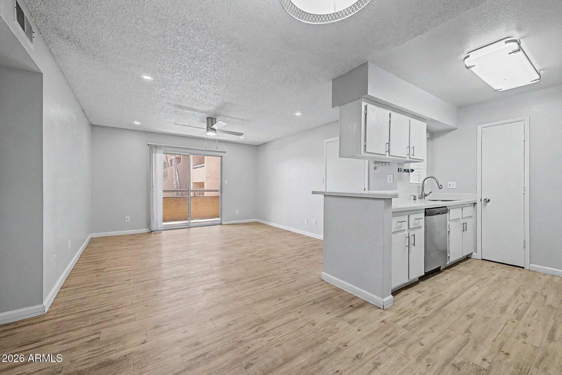 2625 East Indian School Road, Unit 227 Phoenix, AZ 85016 - Photo 6 of 31 a view of a kitchen with wooden floor and electronic appliances