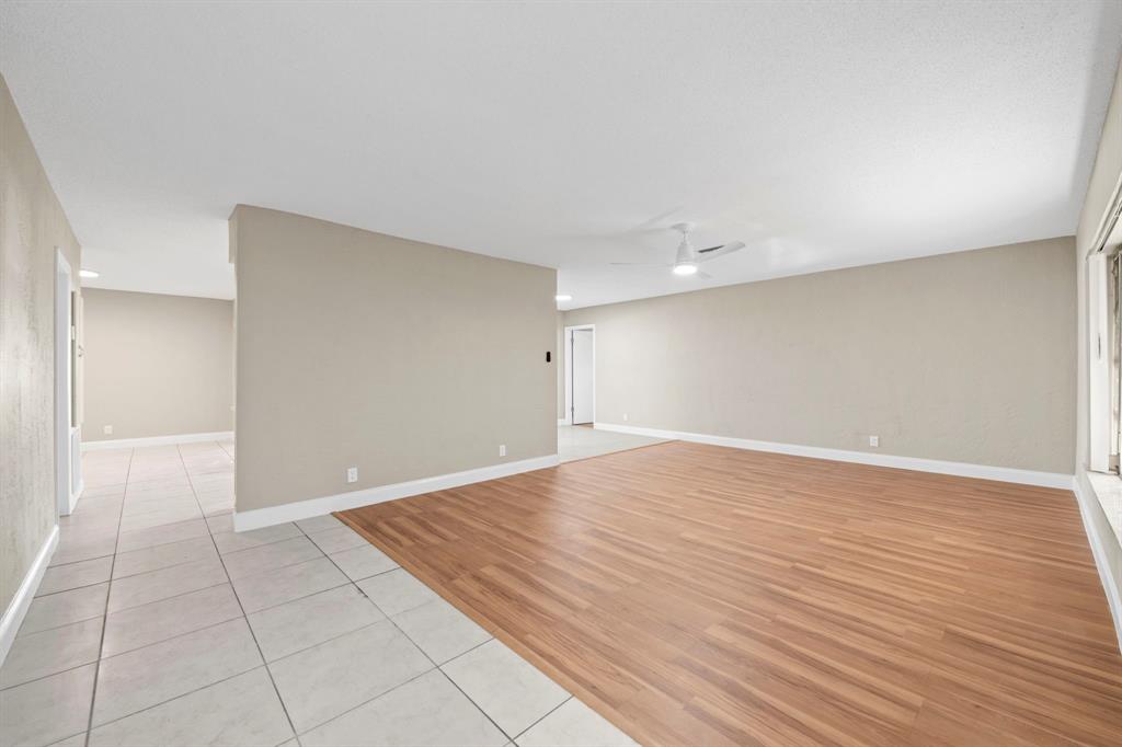 9203 Northwest 71st Street Tamarac, FL 33321 - Photo 11 of 23 a view of an empty room with wooden floor
