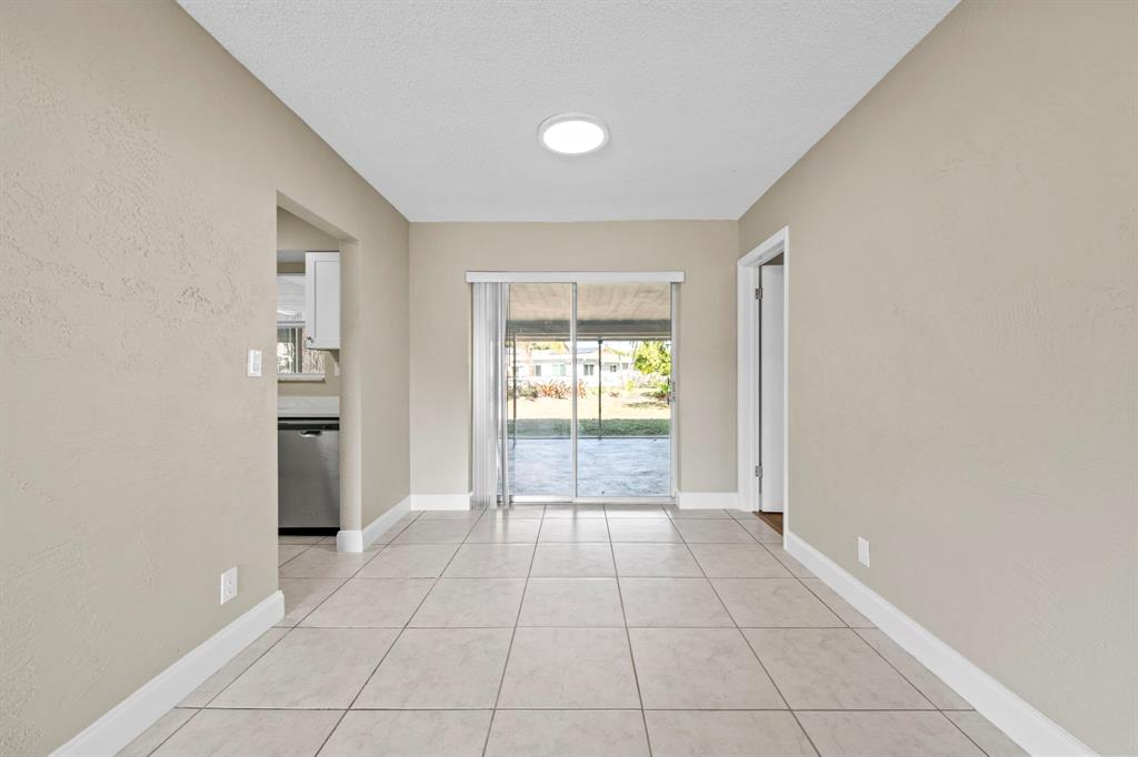 9203 Northwest 71st Street Tamarac, FL 33321 - Photo 8 of 23 a view of an empty room with cabinet and a window