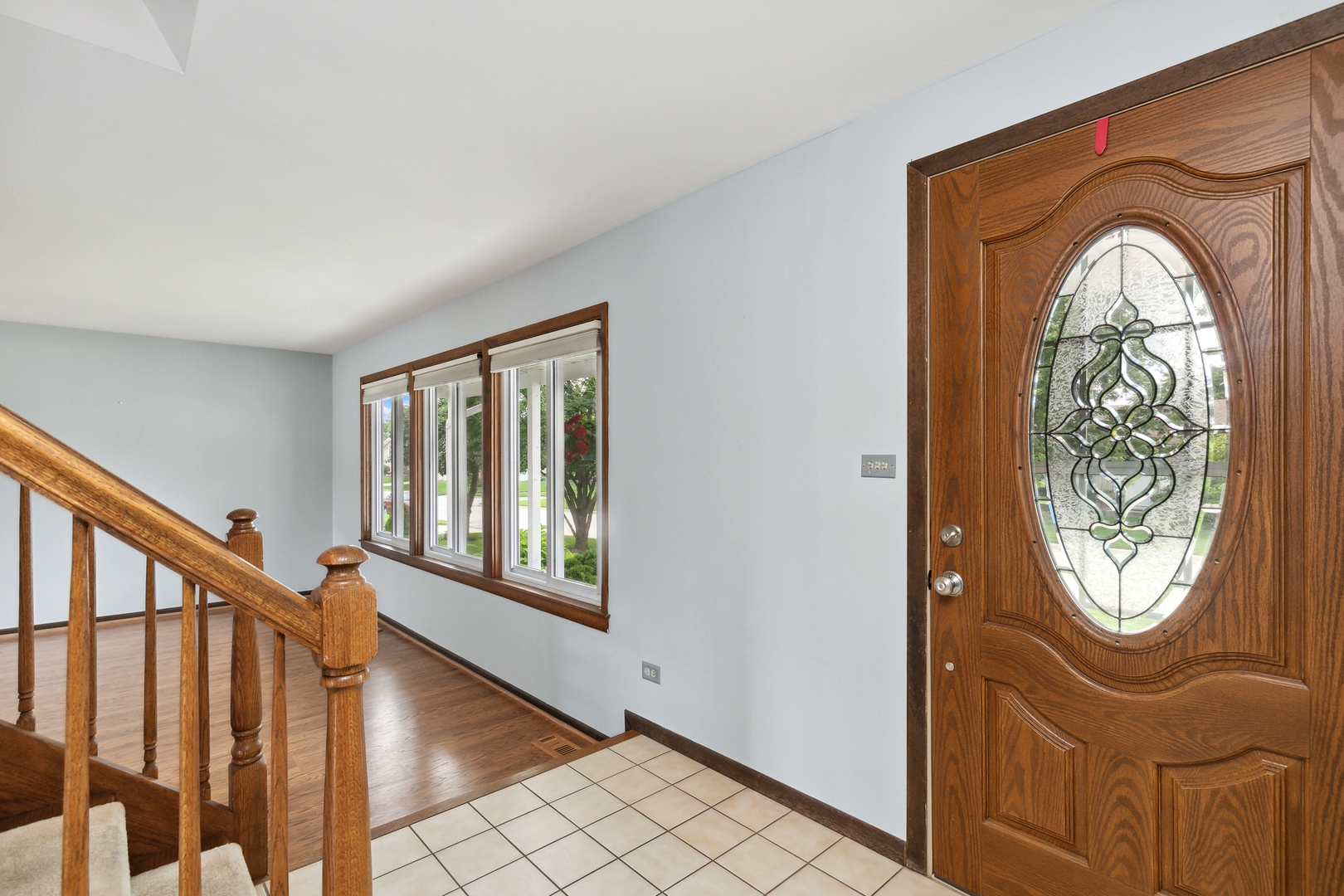 27 Joslyn Drive Elgin, IL 60120 - Photo 2 of 17 an entryway with wooden floor mirror and a window