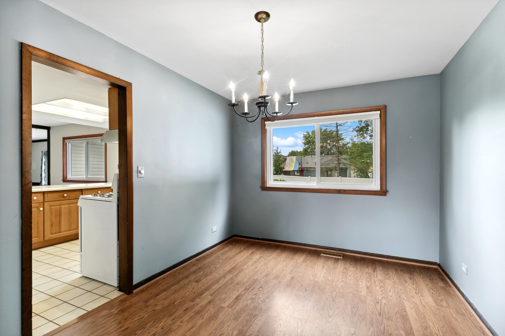 27 Joslyn Drive Elgin, IL 60120 - Photo 4 of 17 a view of a room with wooden floor chandelier and windows