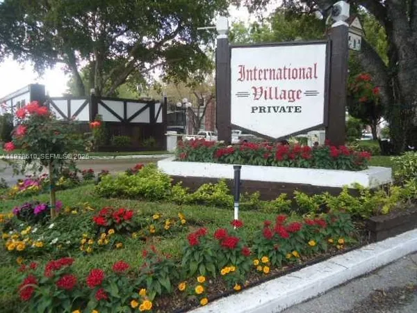 a sign that is in front of flowers