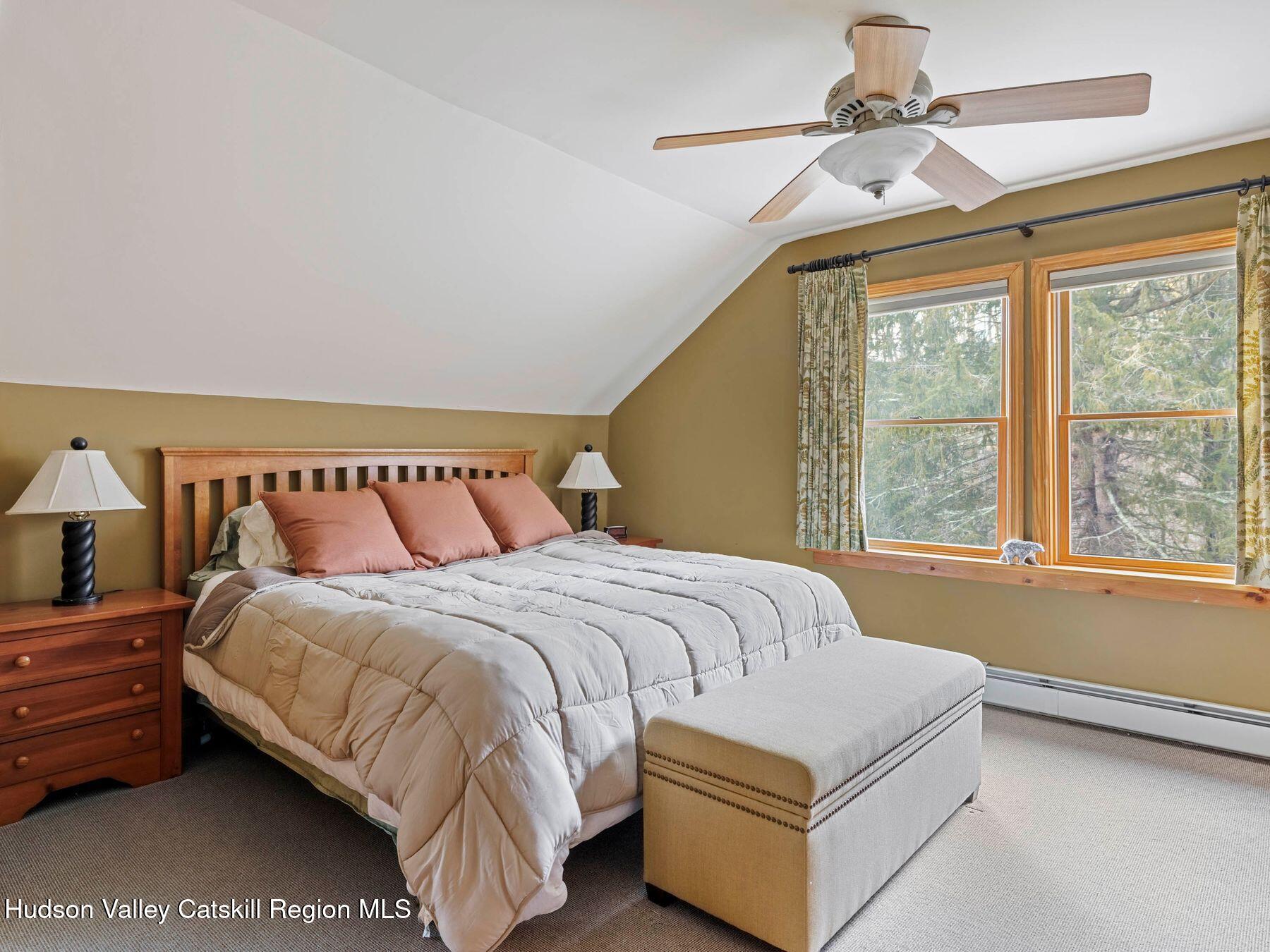 83 Lawrence Road Jewett, NY 12442 - Photo 24 of 52 a bedroom with a bed lamp and a large window