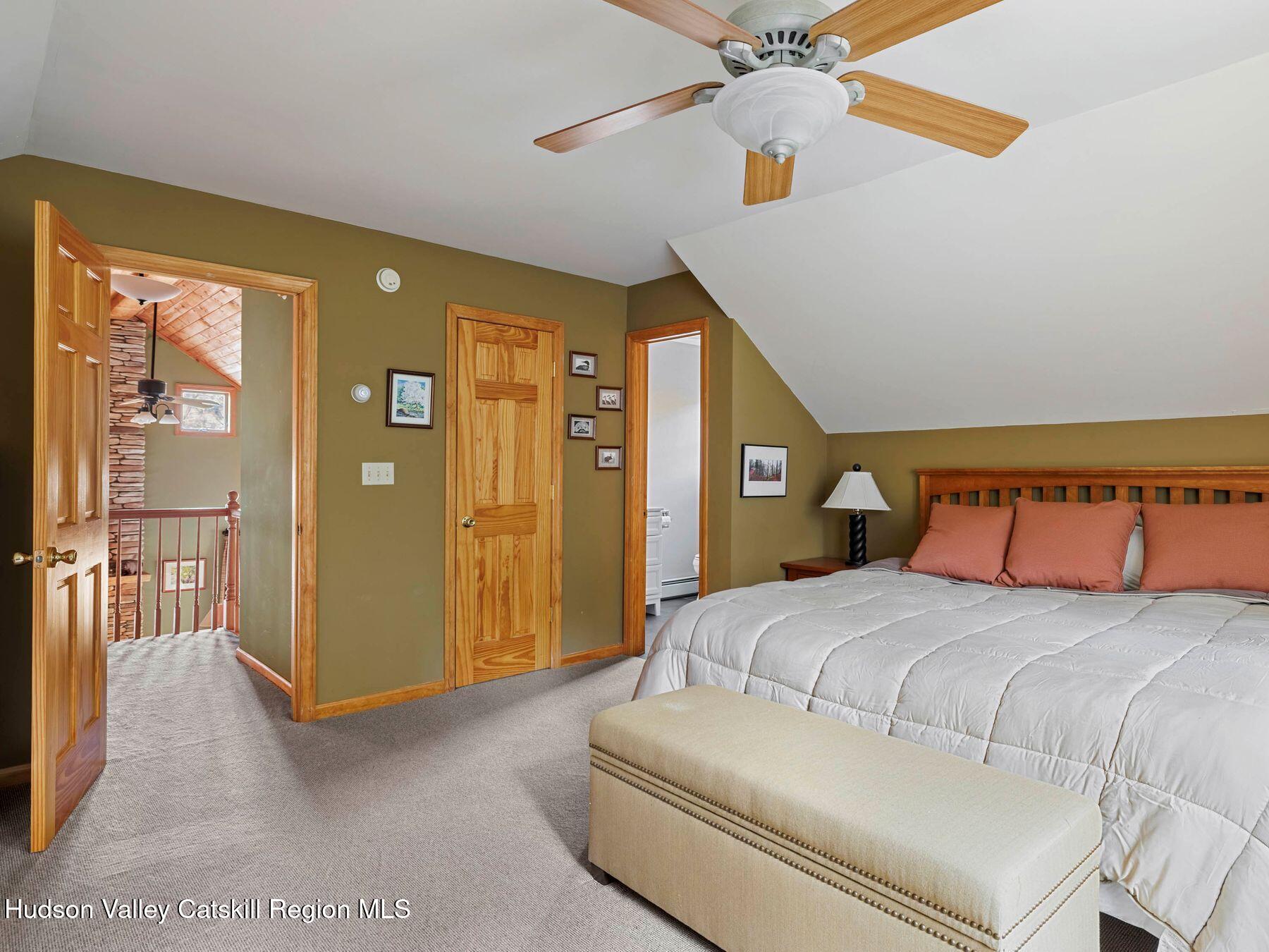 83 Lawrence Road Jewett, NY 12442 - Photo 26 of 52 a bedroom with a bed and a chandelier