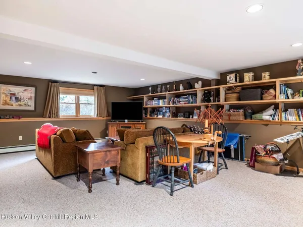 a living room with furniture and a book shelf