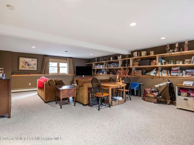a dining room with furniture and a flat screen tv