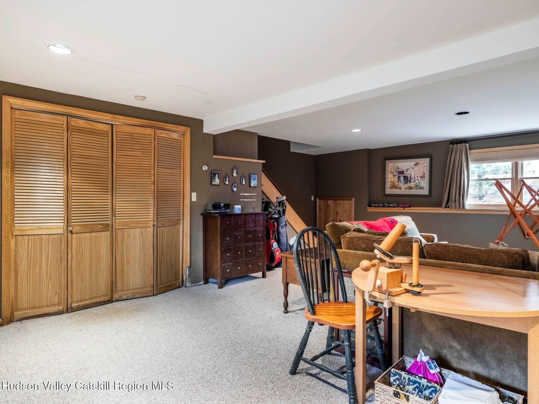 83 Lawrence Road Jewett, NY 12442 - Photo 34 of 52 a dining room with furniture and a flat screen tv