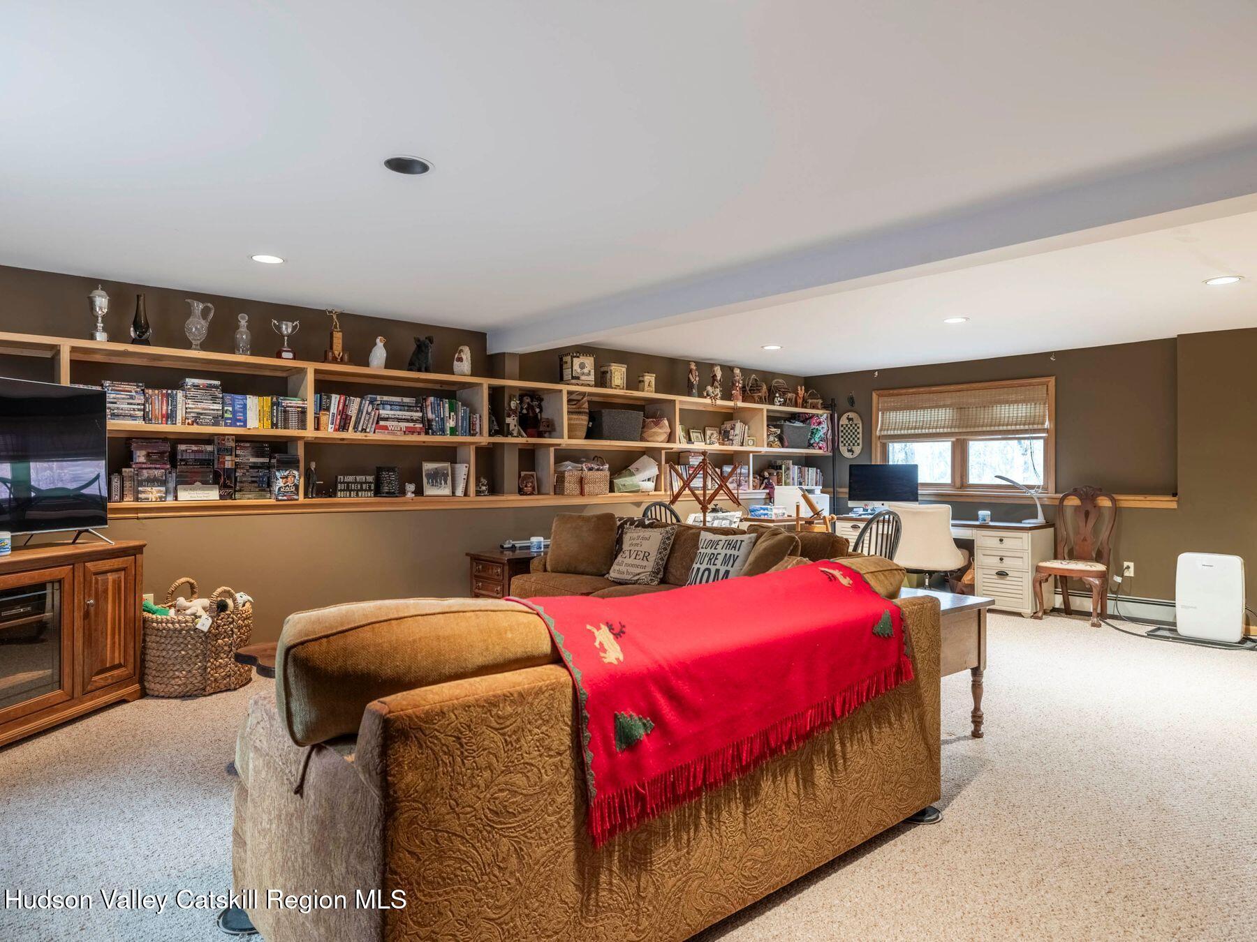 83 Lawrence Road Jewett, NY 12442 - Photo 37 of 52 a room with furniture and a book shelf