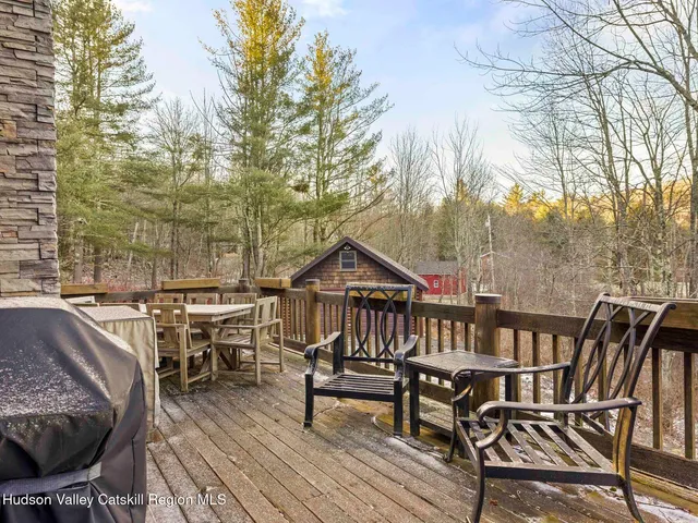 a patio with table and chairs and potted plants