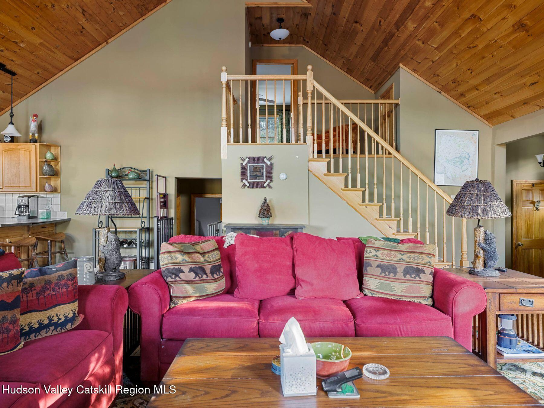 83 Lawrence Road Jewett, NY 12442 - Photo 6 of 52 a living room with furniture a fireplace and a flat screen tv