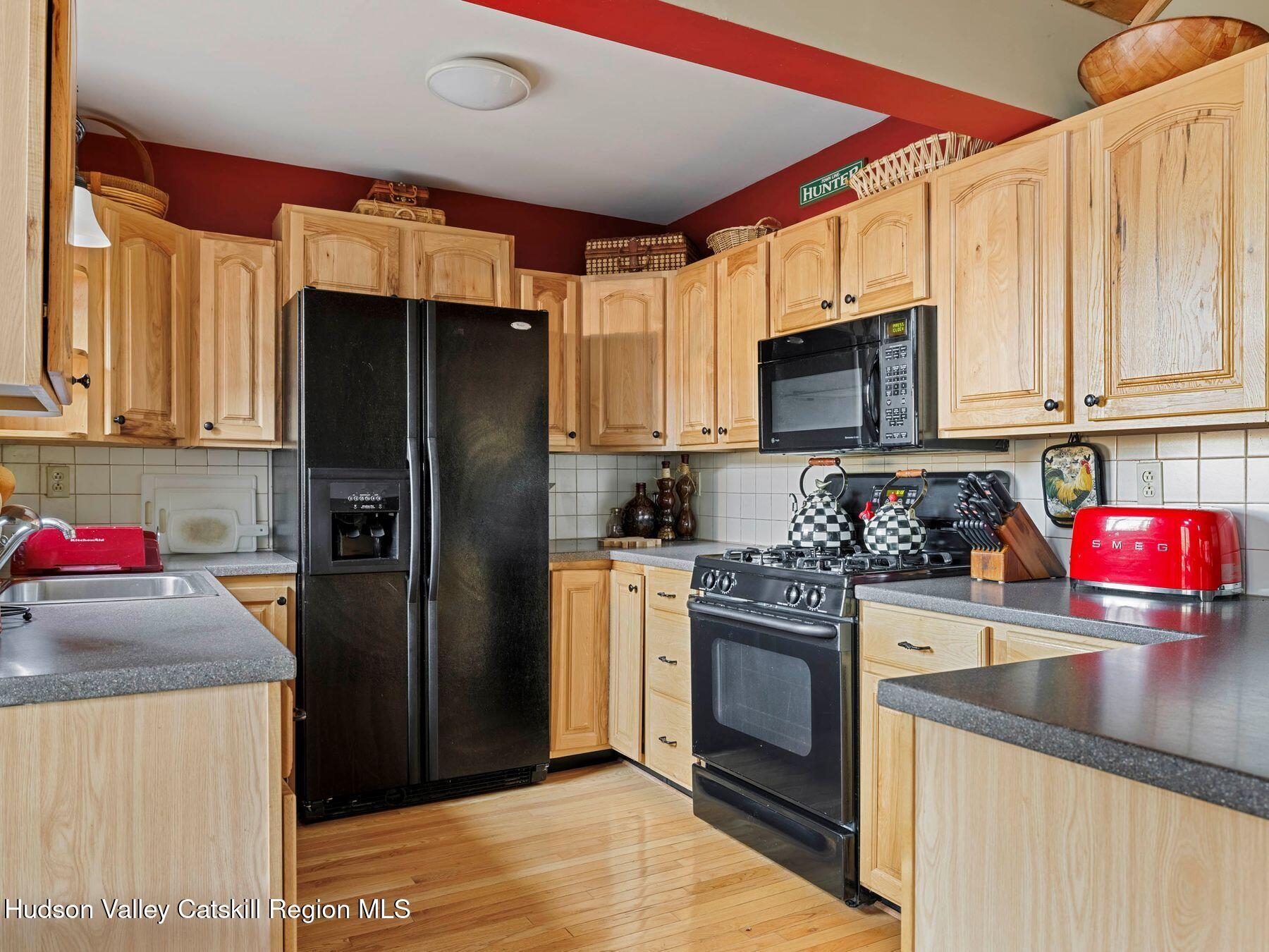 83 Lawrence Road Jewett, NY 12442 - Photo 7 of 52 a kitchen with stainless steel appliances granite countertop a refrigerator stove and sink