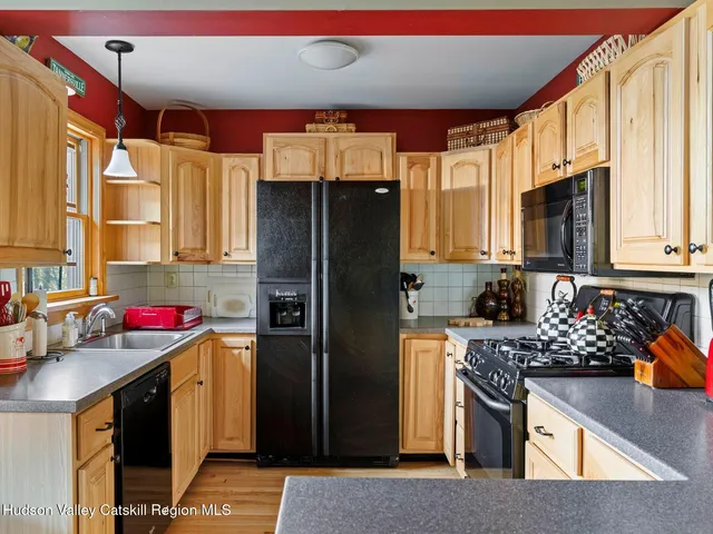 a kitchen with stainless steel appliances granite countertop a refrigerator stove and sink
