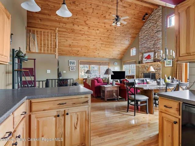 a dining room with furniture a chandelier and wooden floor