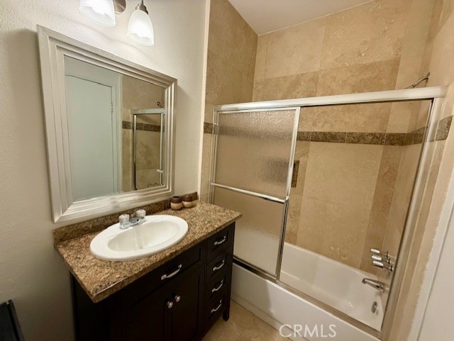 19009 Sherman Way, Unit 34 Reseda, CA 91335 - Photo 14 of 27 a bathroom with a granite countertop sink shower and a mirror