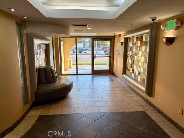 a lobby with furniture and a rug