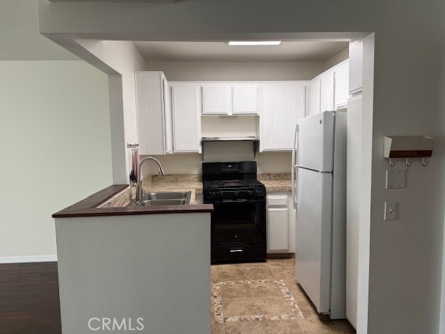 19009 Sherman Way, Unit 34 Reseda, CA 91335 - Photo 4 of 27 a kitchen with stainless steel appliances granite countertop a refrigerator and a stove