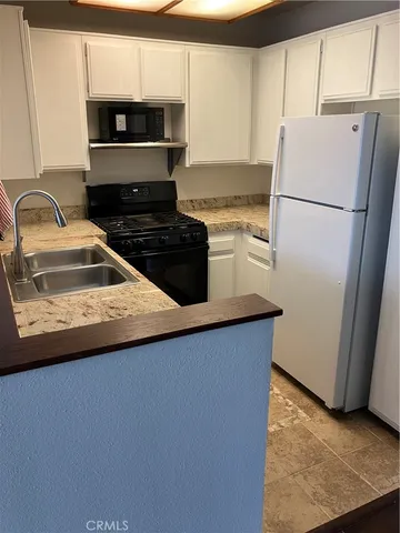 a kitchen with a refrigerator and a sink