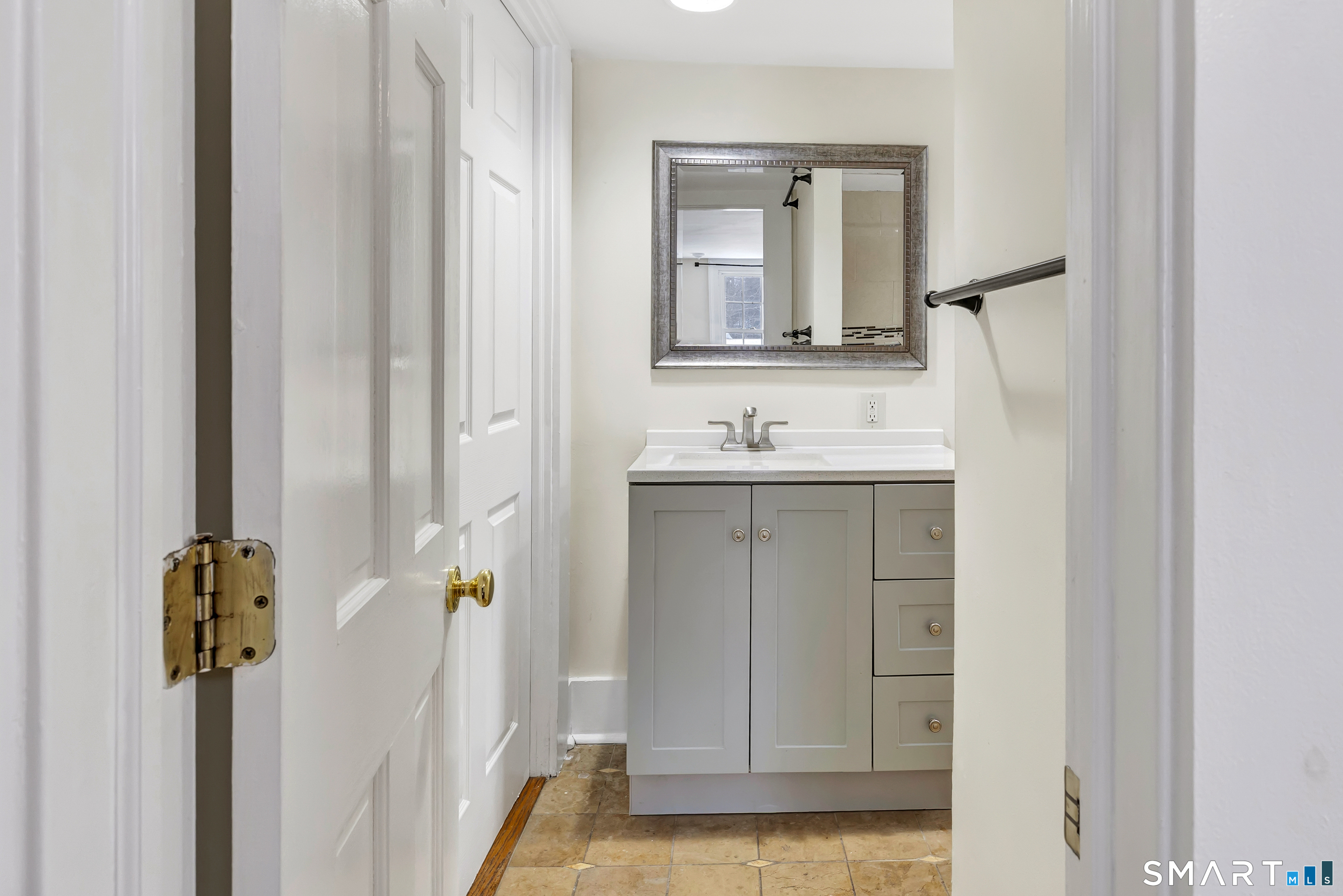 274 Lyons Plain Road Weston, CT 06883 - Photo 17 of 40 a bathroom with a sink and mirror