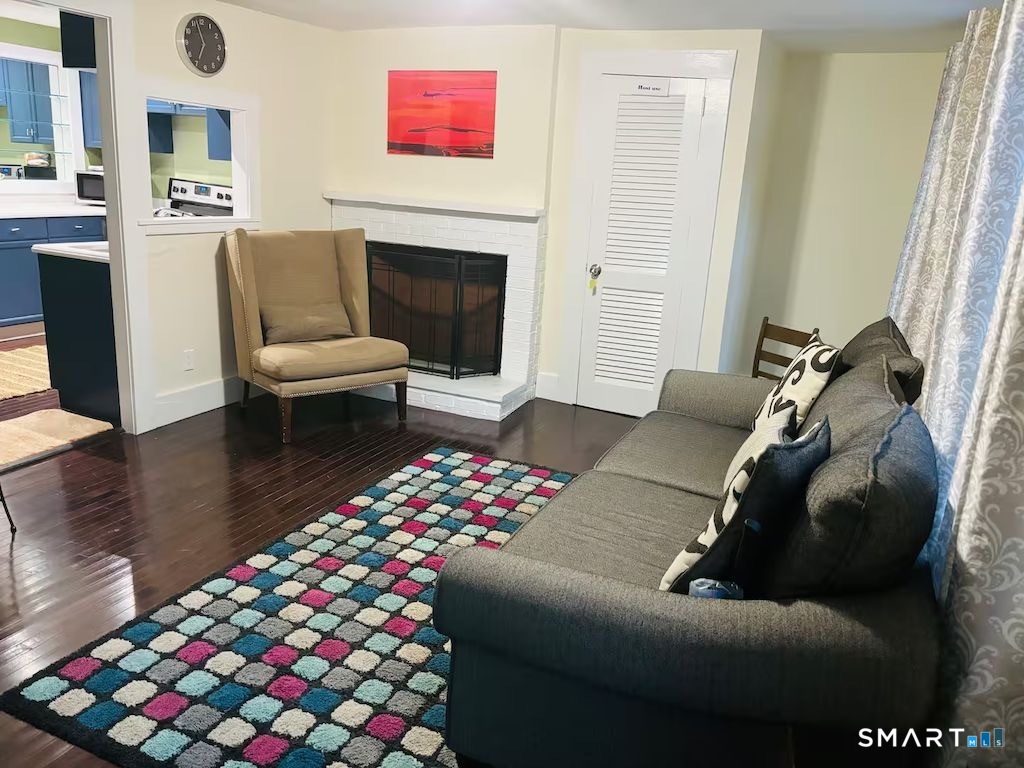 274 Lyons Plain Road Weston, CT 06883 - Photo 21 of 40 a living room with furniture and a fireplace